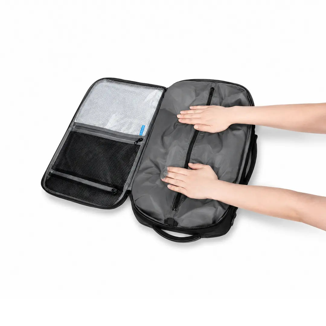 Sac à dos cabine Escale 35L ouvert à plat à 180°, mains qui compressent le compartiment de compression, poches de rangement en maille, Olyneia