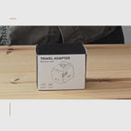 Présentation de l’adaptateur de voyage Olyneia : déballage, manipulation des prises EU, UK, US et AUS, prise secteur femelle universelle et trois ports USB, dont un USB-A et deux USB-C.